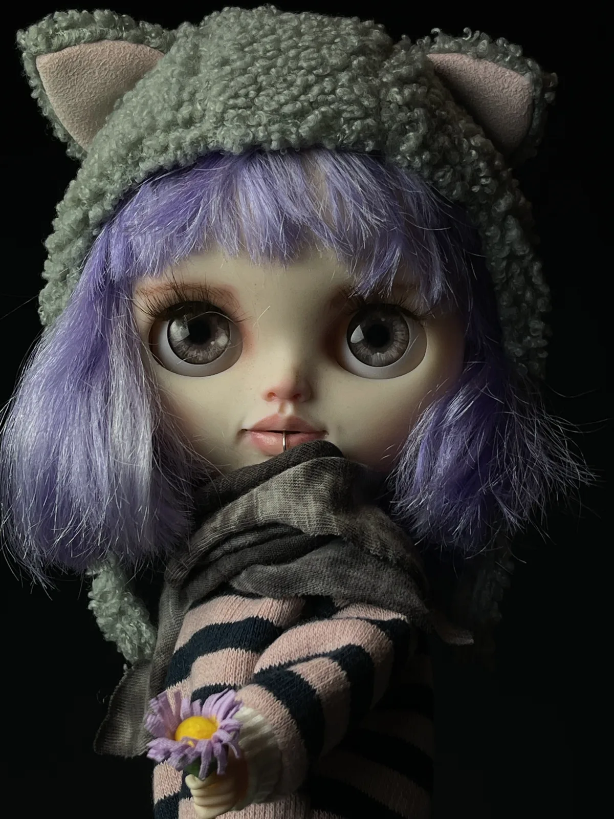 Retrato de Sia con cabello violeta, gorro gris y flores